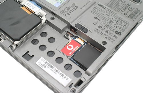 Dell Latitude D420 laptop with an open SIM card slot showing a Vodafone HSDPA card inserted for mobile connectivity.
