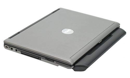 Dell Latitude D420 notebook closed, showing the top cover with the Dell logo, side ports, and battery pack.
