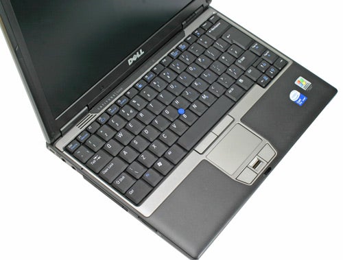 Dell Latitude D420 notebook open on a surface showing the keyboard, touchpad, and display screen with the Dell logo visible on the top corner of the screen.