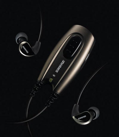 Shure E500PTH Noise Isolating Headphones with black earbuds and volume control module on a dark background.