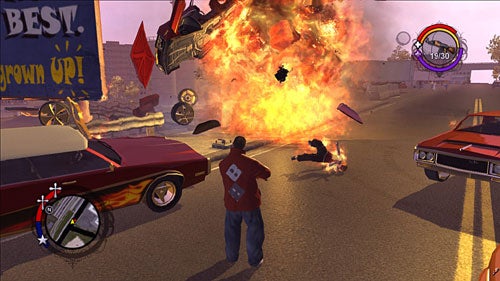 A scene from Saints Row video game where a character is standing in the street observing a fiery explosion with cars and debris flying through the air.
