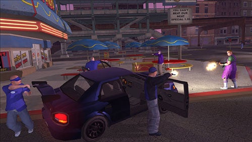 A screenshot from the Saints Row video game showing characters engaged in a shootout beside a blue car in an urban environment at night, with a fast food restaurant and neon signs in the background.