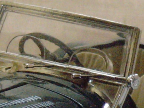 Blurred image of an object with metallic reflections.