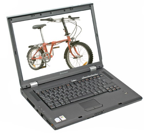 Lenovo 3000 N100 notebook open on a white surface, displaying a vibrant screen image of a red bicycle.