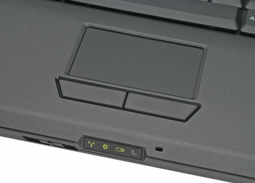 Close-up of the touchpad and buttons on a Lenovo 3000 N100 Notebook with a view of status indicator lights and USB ports on the side.