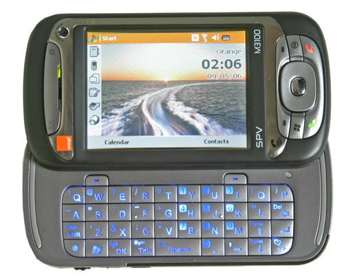 Orange SPV M3100 - 3G Smartphone with a slide-out QWERTY keyboard, displaying a home screen with clock and quick access buttons, set against a white background.