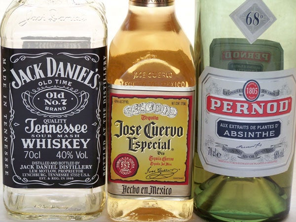 Three bottles of different alcoholic beverages, including Jack Daniel's Tennessee Whiskey, Jose Cuervo Especial Tequila, and Pernod Absinthe, displayed side by side.