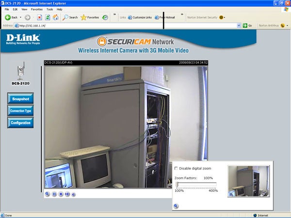 Screenshot of D-Link Securicam DCS-2120 IP Camera's interface on Internet Explorer showing the camera's view of a room with a computer and server racks.