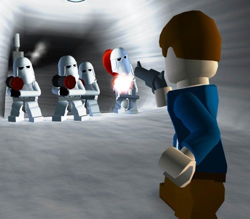 A screenshot from the video game Lego Star Wars II: The Original Trilogy showing a Lego character resembling Han Solo aiming a blaster at approaching Stormtroopers in a corridor-like setting.
