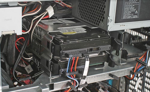 Internal view of a Dell XPS 700 desktop computer showing the hard drive mounted horizontally with various power cables and data connectors attached.