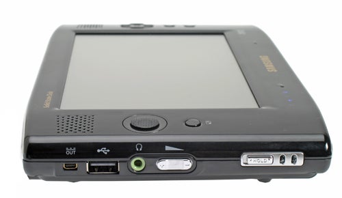 Samsung Q1 Solid State UMPC with visible ports and controls, showing the screen, power button, speakers, and connectivity options on its edge.
