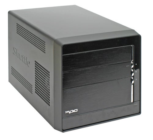 Shuttle XPC SN27P2 small form factor barebone PC with a black front panel featuring drive bays and the Shuttle logo, standing upright on a plain surface.