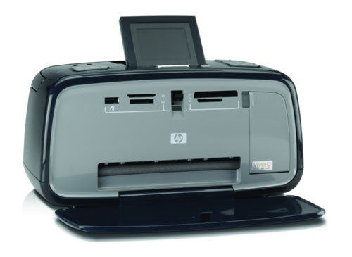 HP Photosmart A618 compact photo printer with open paper output tray and lid, displaying the HP logo and memory card slots on the front.