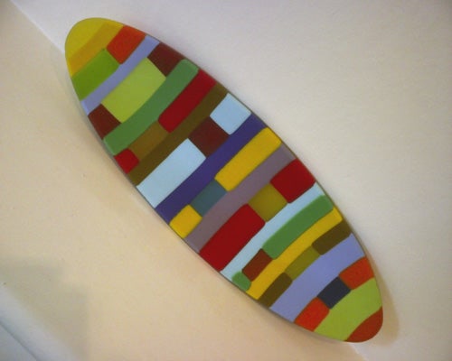 Colorful abstract surfboard-shaped artwork on a white background.