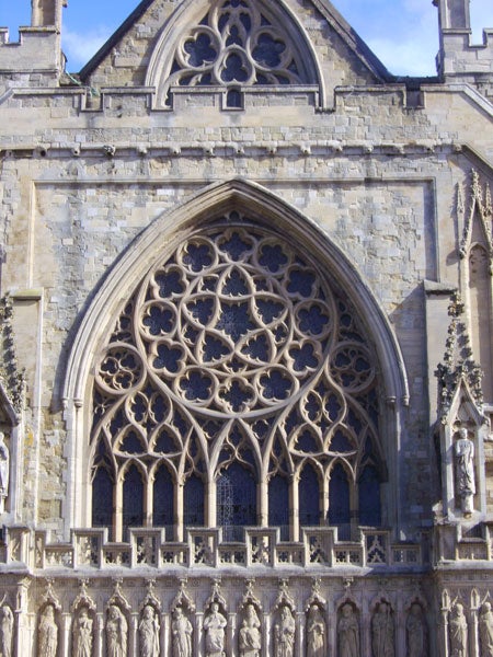 A detailed photograph displaying the intricate Gothic architecture of a cathedral's facade, highlighting the precision of the BenQ DC C1000 10-Megapixel Compact Camera in capturing texture and design with clarity.