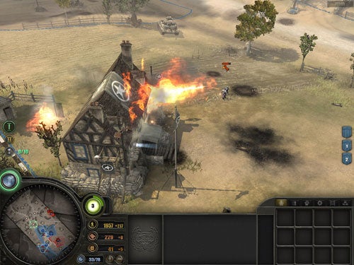 Screenshot from the video game Company of Heroes showing a battle scene with a burning building, soldiers in combat, and the in-game user interface including a minimap and resource counters.