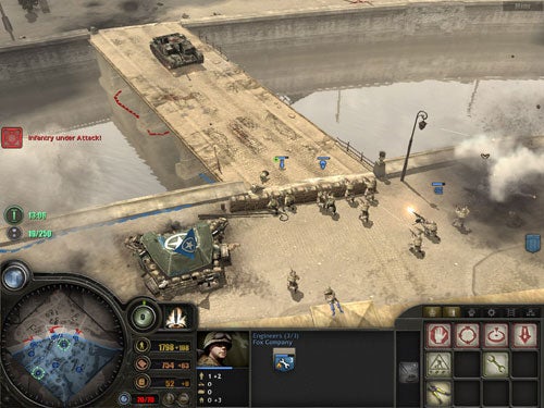 Screenshot from the video game Company of Heroes showing an in-game battle scenario with troops and a tank on a bridge, user interface elements indicating resources and map, and alert message for enemy unit attack.