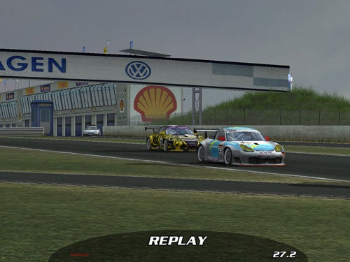 Two racing cars on a track during a replay moment in a racing video game, with a prominent Shell and Volkswagen sponsorship in the background.