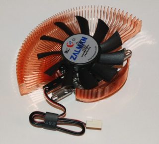 Zalman VF700-CU VGA cooler with a copper heatsink and black fan mounted on top, with a 3-pin power connector.