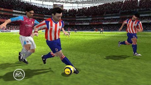 Soccer players from opposing teams in a FIFA 07 video game match, showcasing in-game graphics with one player dribbling the ball while another attempts to defend, in a virtual stadium setting.