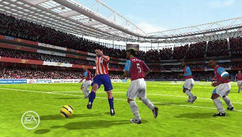 Screenshot of gameplay from FIFA 07 showing virtual football players from two teams competing on the pitch in a stadium with filled stands.
