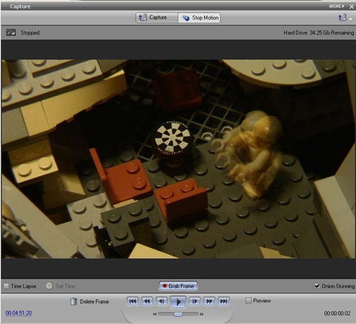 A screenshot of Adobe Elements Bundle 5.0 software interface during a stop-motion capture process, showing a Lego scene with a minifigure and props, and tools for video editing including time-lapse and onion skinning options.