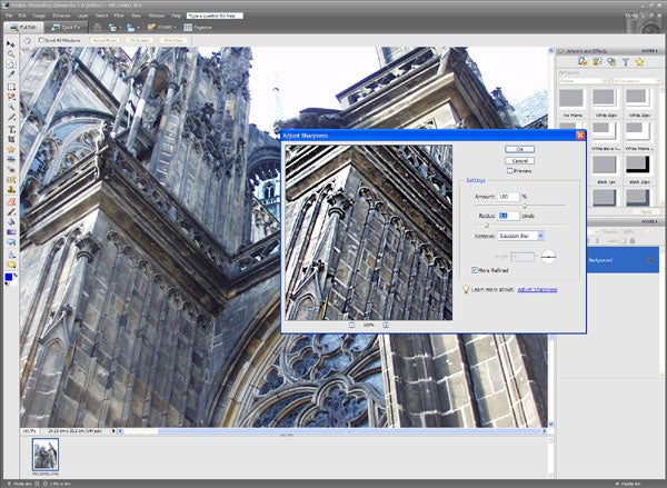 Screenshot of Adobe Photoshop Elements with a photo of a cathedral being edited, showing the software's user interface with toolbars and an 'Adjust Sharpness' dialog box open.