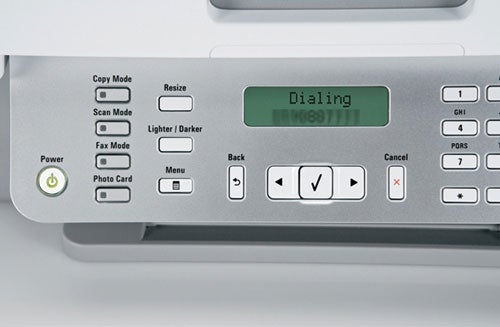Control panel of Lexmark X5470 All-in-One printer showing dialing on LCD screen with copy mode and resize buttons visible.