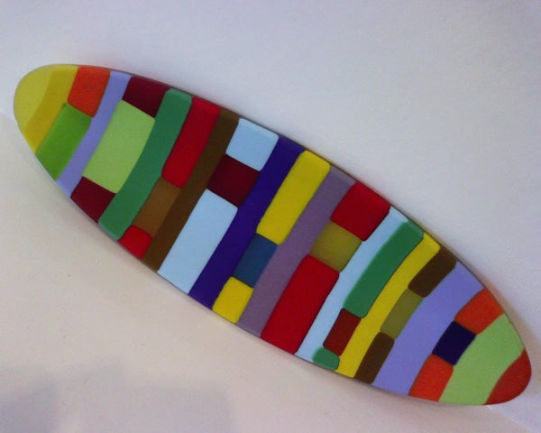 Colorful artistic skateboard deck on a white background.