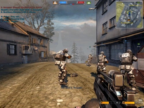 Screenshot from the video game Battlefield 2142 showing a first-person view of the player holding a gun with teammates in futuristic armor on a battlefield environment.