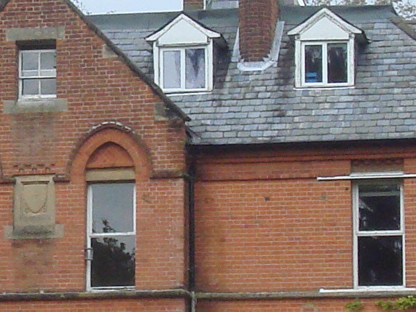 Image showing a close-up view of a red brick house with multiple windows, demonstrating the clarity and zoom capability of the Sony Cyber-shot DSC-T10 camera.