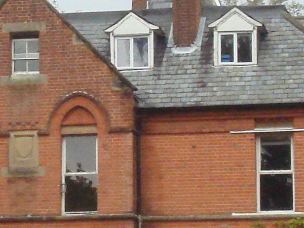 Close-up photograph of a brick building with a slate roof, taken with a Sony Cyber-shot DSC-T10 camera showcasing the camera's image quality.