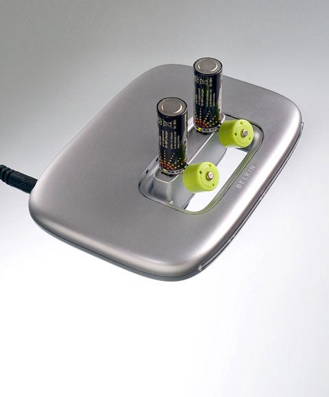 Moixa USBCell AA batteries charging on a metal charging dock with USB cable attached.