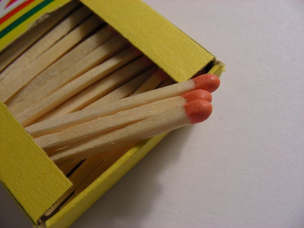 Close-up photo of matchsticks in an open matchbox, showcasing the macro photography capabilities of the Nikon Coolpix S10 camera.
