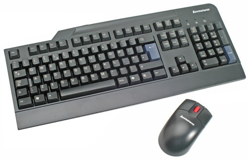 A Lenovo branded black keyboard with a full set of keys, including a number pad, accompanied by a Lenovo mouse with a red scroll wheel, both placed on a white surface.