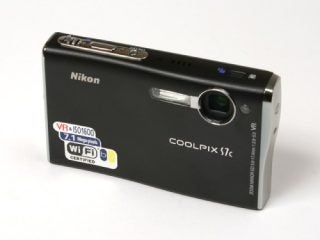 Nikon Coolpix S7c digital camera with 7.1 megapixels and Wi-Fi certification displayed on white background.