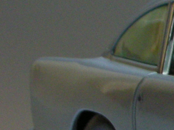 A blurred image of a section of a car, demonstrating potential image clarity issues when using the Nikon Coolpix S7c digital camera.