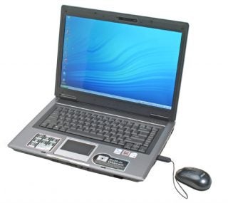 Asus F3JP Core 2 Duo Notebook open on a desk displaying screen and keyboard, with a mouse connected to the right side.
