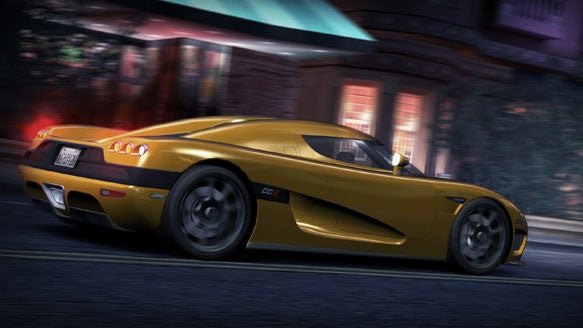 A yellow sports car from the video game Need for Speed: Carbon racing through a city street at night.