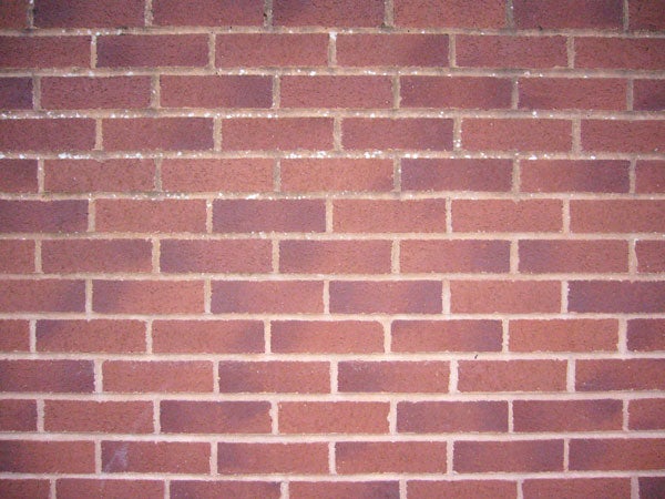 A close-up image showing the texture and pattern of a red brick wall.