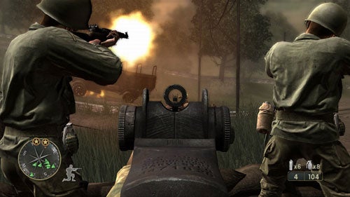 Screenshot from Call of Duty 3 showing first-person gameplay with a soldier aiming a rifle, fellow soldiers advancing, and an enemy vehicle on fire in a battlefield environment.