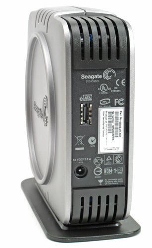Seagate 500GB eSATA external hard disk standing upright on a black stand, displaying the rear panel with eSATA and USB connection ports, power input, and regulatory compliance labels.