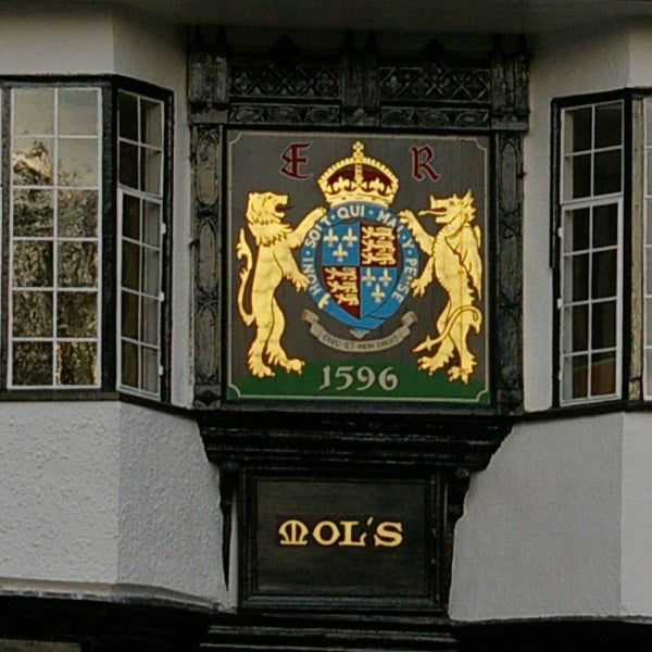 Historic building crest with lions and a date from 1596.