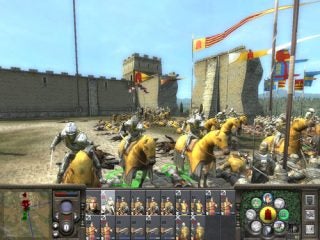 Screenshot of Medieval 2: Total War game showing a battle scene with cavalry in the foreground and a castle in the background, including game interface with unit selection and map at the bottom.