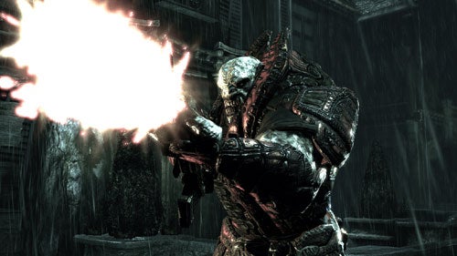 A character from the video game Gears of War is seen firing a weapon with a bright muzzle flash, set against a dark, rainy backdrop.