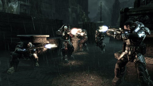 A scene from Gears of War showing characters in combat, taking cover behind walls while firing weapons at off-screen enemies, with muzzle flash visible, all under heavy rain conditions.