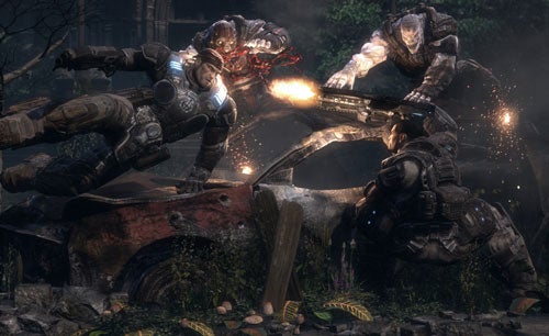 Scene from Gears of War game showing characters in combat with a fiery explosion and debris, illustrating intense gameplay graphics.