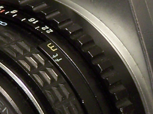 Close-up view of the focus ring and aperture settings on a Kodak EasyShare Z710 camera lens.