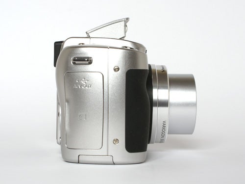 Kodak EasyShare Z710 digital camera displayed on a plain background, showing its silver body, lens extended, flash popped up, and black grip.
