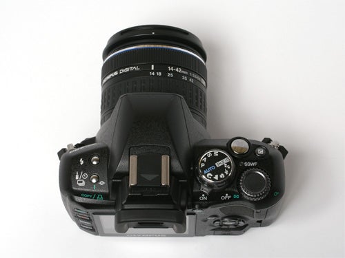 Olympus E-400 DSLR camera with a 14-42mm lens viewed from the top showing control dials and buttons.